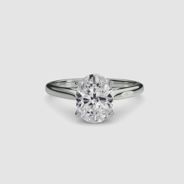 Solitaire white gold ring with a large oval-cut diamond on a white background