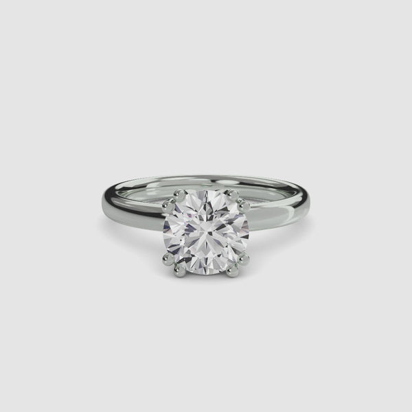 360 angle of view of a white gold solitaire engagement ring featuring a large round brilliant-cut diamond secured by eight ball-tipped prongs in a floral basket setting, with a plain polished band.