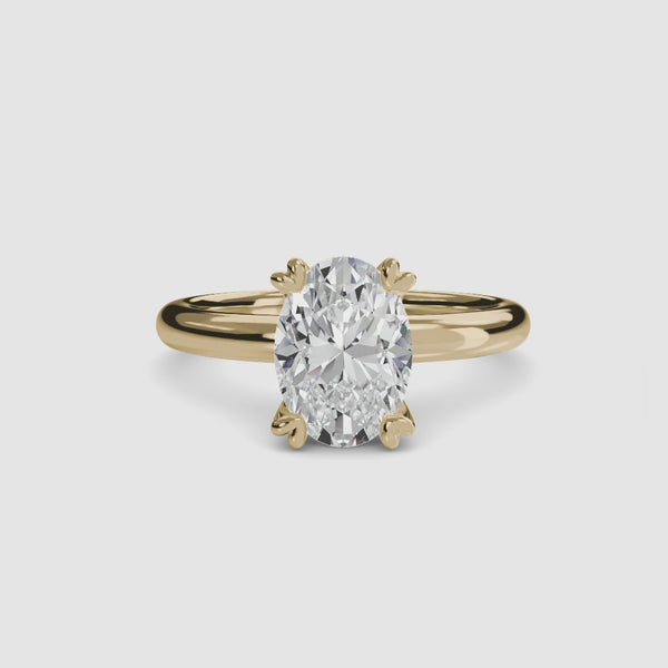 360-degree rotation view the Alaria oval cut diamond double prong solitaire engagement ring in yellow gold