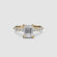 Gold ring with a large emerald-cut diamond and smaller diamonds on the sides against a white background