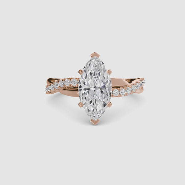 Rose Gold ring with a marquise-shaped diamond twisted pave band on a white background