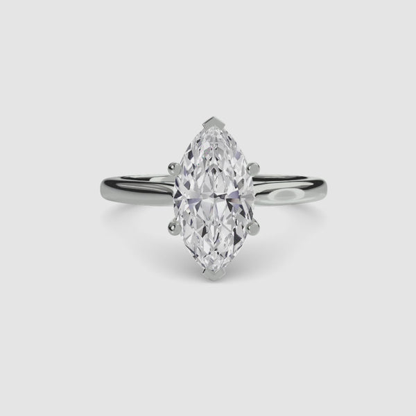 Solitaire diamond ring with a marquise-shaped gemstone in white gold setting