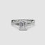 White gold ring with a large emerald-cut diamond and smaller diamonds on the twisted band against a white background