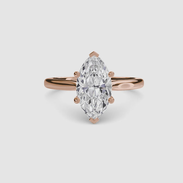 Rose gold solitaire ring with a marquise-shaped diamond 