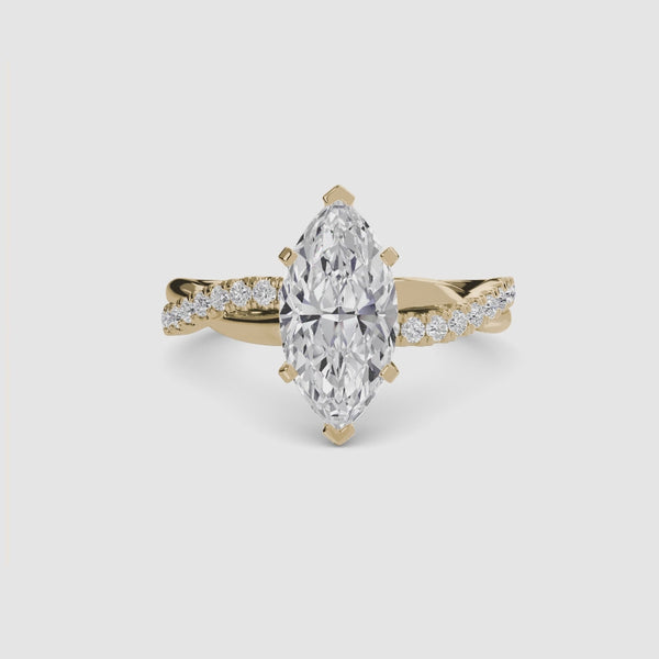 Gold ring with a marquise-shaped diamond twisted pave band on a white background