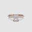 Rose gold ring with a central radiant cut diamond and marquise and round side stones on the band on a white background