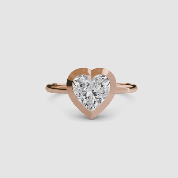 Heart-shaped diamond bezel ring with rose gold solitaire setting 