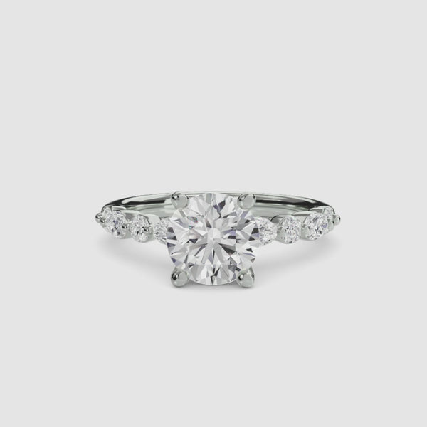 Round diamond ring with side stones white gold a white background
