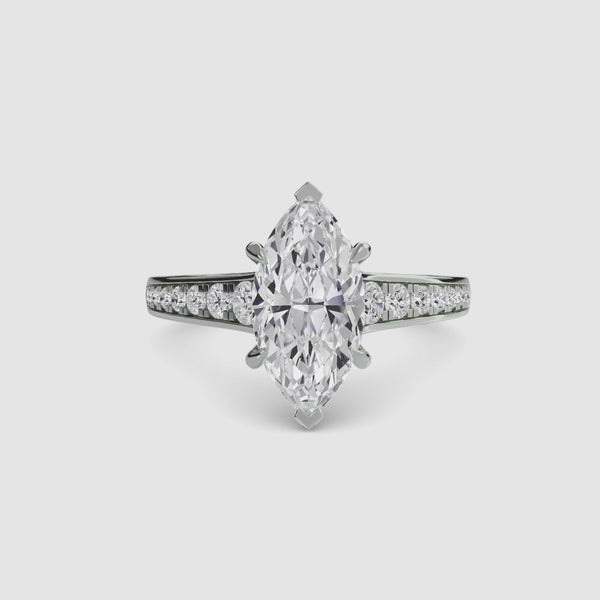 Diamond ring with a marquise-shaped center stone on a white background