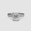 Diamond ring with emerald-cut center stone and smaller diamonds on a white background