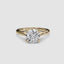 Gold solitaire ring with a round diamond brilliant cut on a white background