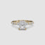Gold ring with a central radiant cut diamond and marquise and round side stones on the band on a white background