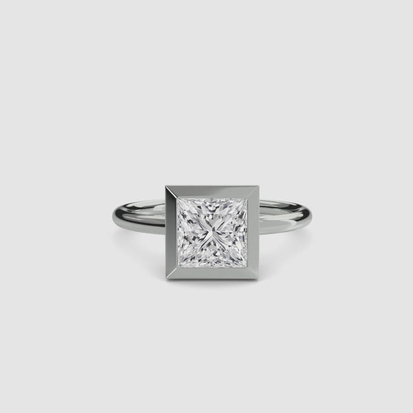 Solitaire white gold ring with a princess-cut diamond bezel set