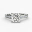 Princess cut diamond ring with a graduated pave diamonds on the shank on a white background