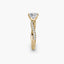 Gold ring with a large princess-cut diamond and smaller diamonds on the twisted u-pave band against a white background