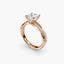 Rose gold ring with a diamond on a white background