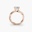 Rose gold ring with a diamond on a white background