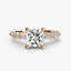 Rose Gold ring with a large central princess diamond and smaller diamonds on the band against a white background