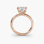 Front-facing view of a rose gold solitaire engagement ring with a princess-cut diamond in an eight-prong tulip basket setting, showcasing the open gallery and plain rounded band against a light gray background.