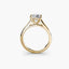 Solitaire gold ring with a diamond on a white background