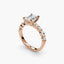 Rose gold ring with a central diamond and smaller stones on a white background