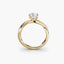 Gold ring with a radiant-cut diamond and pave shank on a white background