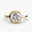 Round bezel diamond ring in solitaire yellow gold setting
