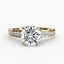 Gold ring with a large round diamond and smaller diamonds on the band against a white background