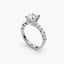 Diamond ring with a central gemstone and smaller stones on a white background