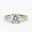Gold ring with a large round diamond and smaller diamonds on the band against a white background