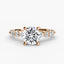 Rose gold ring with a large round diamond and smaller diamonds on the band against a white background