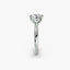 Profile view of The Caelis double prong securing round diamond solitaire ring in white gold