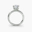 Front-facing view of a white gold solitaire engagement ring with a round diamond in an eight-prong tulip basket setting, showcasing the open gallery and plain rounded band against a light gray background.