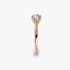 Rose gold ring with a diamond on a white background