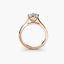 Rose gold solitaire ring with a diamond on a white background