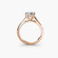Rose gold solitaire ring with a diamond on a white background