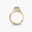 Solitaire gold ring with a diamond on a white background