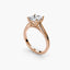 Rose gold solitaire ring with a diamond on a white background