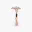 Rose gold ring with three diamonds on a white background
