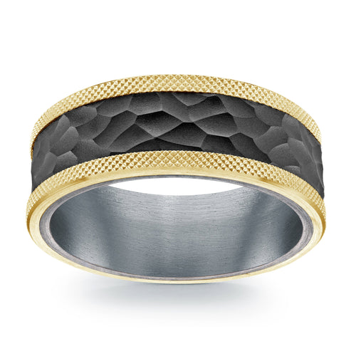 Titanium ring with gold hammered finish on a white background